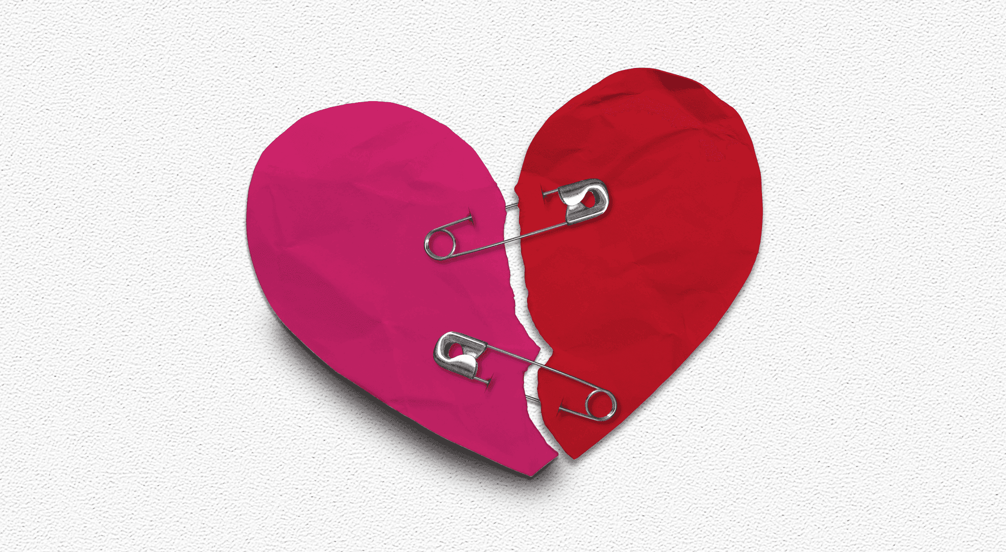 a heart held together with safety pins